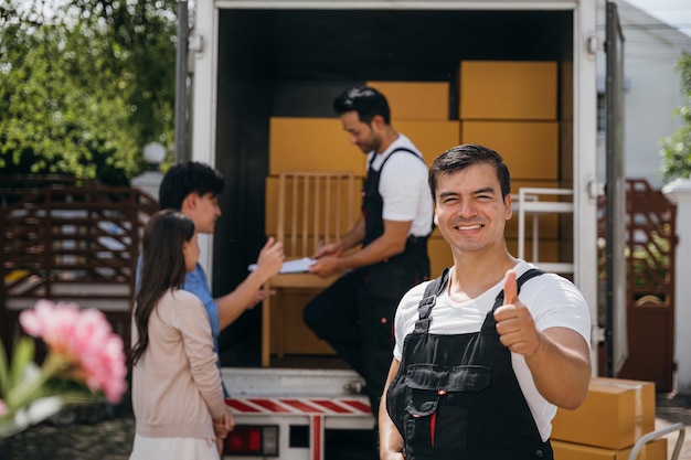 portrait happy mover working unloading boxes into new home from truck these removal company workers ensure smooth relocation spreading joy moving day concept 143683 22127